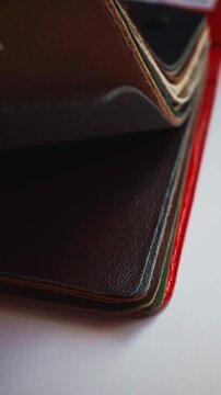 Assorted leather samples arranged for furniture and interior design selection, showing different colors, textures, and grain finishes. Vertical animated choice of leather for design of furniture
