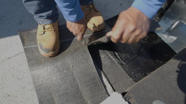 Roofer applying granulated APP Torch Down 