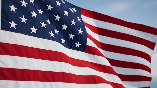 American Flag Waving in the Wind with Blue Sky Background