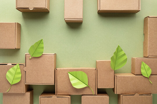 Kraft boxes from recyclable organic materials with green leaf. Eco friendly packaging, zero waste and plastic free concept.