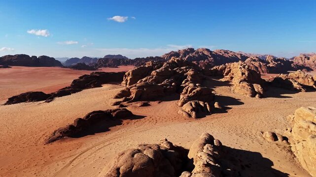 Capturing the rugged beauty of the Jordanian wilderness in clear daylight, this aerial shot reveals the unique geological features and vast horizon of the desert