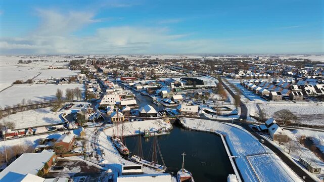 Snowy historic European city and harbor in winter