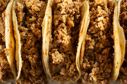 A top down view of several carne asada tacos, as a background.