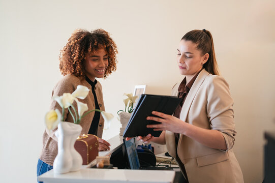 Client checking in at wellness spa reception desk