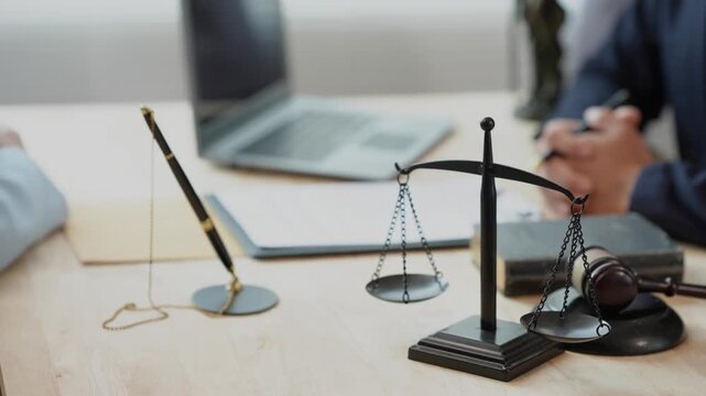 The concept of law and justice: The lawyer provides legal advice to young female lawyers, discusses legal documents, and offers guidance on important cases.