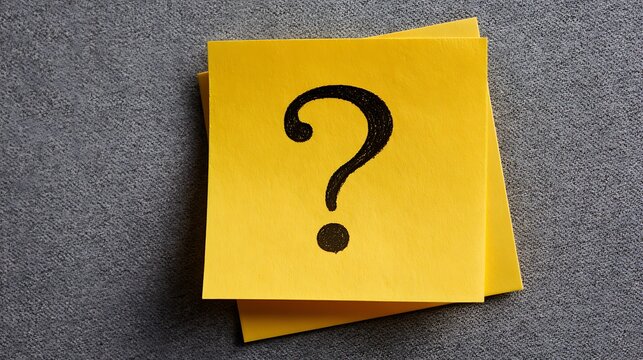 Awesome photo of question mark symbol hand drawn on a yellow sticky note against a grey textured background.