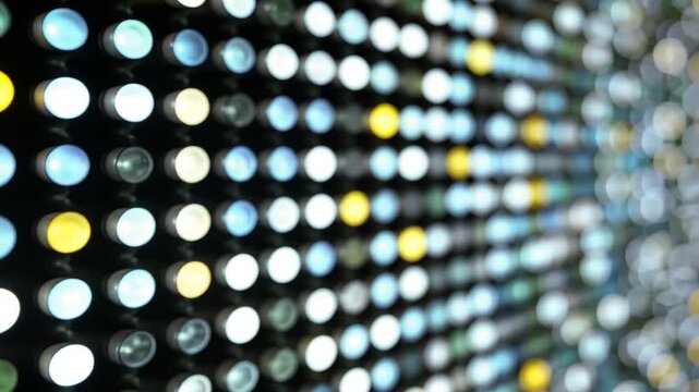 Close-up view of a screen displaying numerous colorful circular lights arranged in rows.