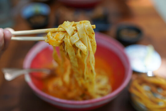Thai Food, Northern Style Curried Noodle Soup or what we call in thai Khao Soi on wooden table.