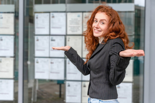 Woman shows confusion outside job listing board in city