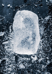 Natural textured ice block, isolated on a black background among the ice crush.
