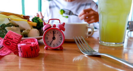 Intermittent Fasting and Meal Timing with Pink Alarm Clock for a Balanced Diet
