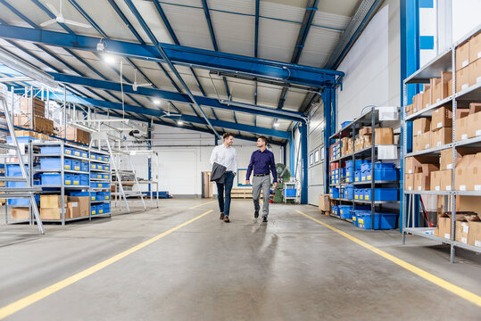 Business meeting in modern production hall warehouse