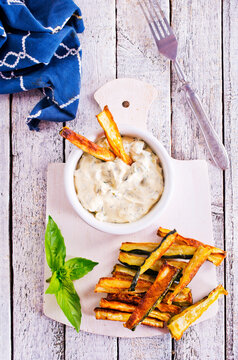 Baked crispy eggplant sticks served with white sauce. Vegetarian healthy dish.
