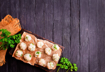 Homemade beef and pork meatballs on baking paper.
