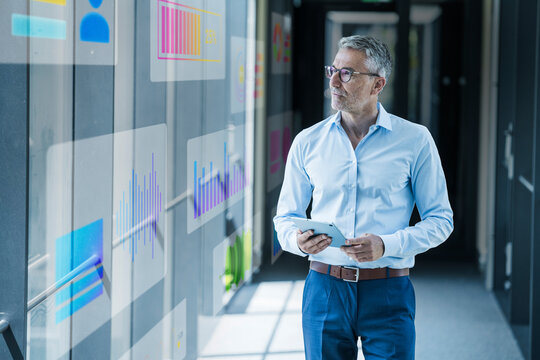 Business professional analyzing digital data charts in modern office