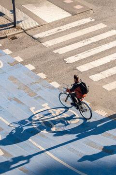 Urban Copenhagen Denmark cycleway crossing with bicycle cyclist under traffic lights showing commute movement and infrastructure planning from above