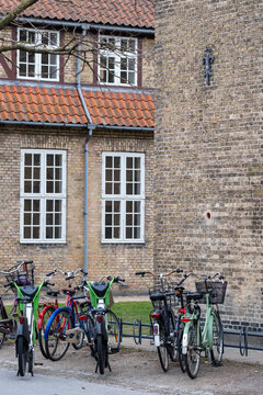 Copenhagen street bicycle parking outside a brick building facade with urban architecture and Denmark atmosphere for local everyday travel
