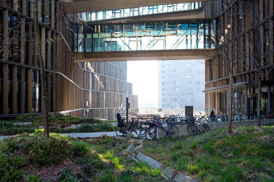Urban exterior bicycle passage in Copenhagen Denmark framed by modern architecture and building corridor showing infrastructure geometry and light