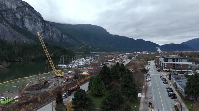 Construction Site On Marina Port In Squamish With Stawamus Chief In The Background In British Columbia, Canada. Aerial Shot