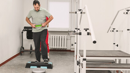 Fototapeta premium Elastic resistance band for gait training in physiotherapy. Used to increase walking difficulty during step platform and obstacle course exercises, improving strength, balance, coordination, and motor