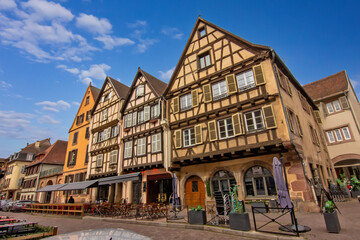 Historic colorful timber houses around a quiet cobblestone square in Colmar.