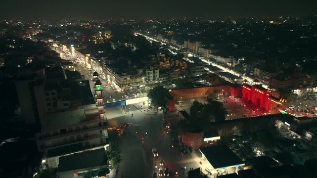 Aerial view of the illuminated buildings and streets creating a stunning contrast against the dark sky, Ashok Nagar, Rajasthan, India.