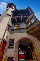 Colorful historic timber house with ornate balcony and medieval architecture in Colmar.