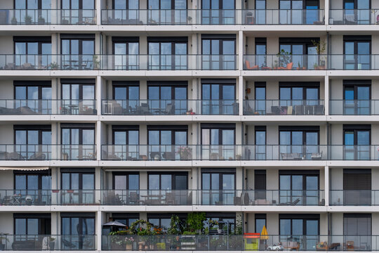 Modern architecture facade of residential apartment building balconies forming a grid pattern in HafenCity district in Hamburg Germany with strong urban rhythm