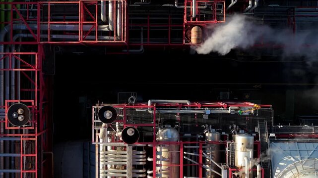 Aerial view of Sutton Bridge Power Station, a sprawling industrial complex with intricate pipe networks and plumes of steam rising, Sutton Bridge, United Kingdom.
