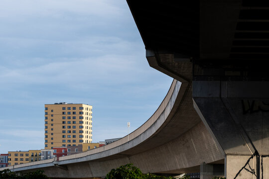 Urban architecture rises behind a concrete overpass with sweeping curve and skyline in berlin germany reflecting infrastructure mobility