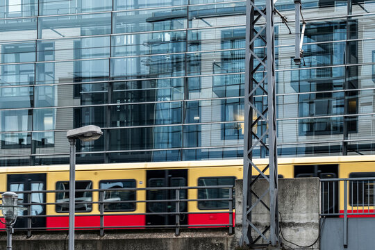 Modern cityscape windows frame a railway commuter train in berlin germany showing transport infrastructure and urban mobility today network