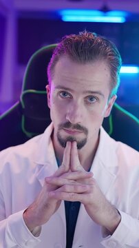 Cyber geek in lab coat interested in your nonsense looking at camera