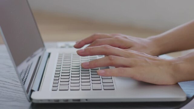 Close-up of Hands Typing on Laptop at Home