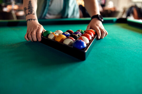 Close-up of billiards player arranging balls on table