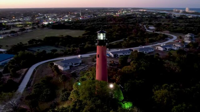 Aerial view of the Jupiter Lighthouse Park with its vibrant lighthouse and surrounding waters during twilight, Jupiter, Florida, United States.