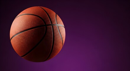 Obraz premium Classic orange basketball in mid-air, vibrantly illuminated against a rich purple background, capturing the spirit of competitive sport and active lifestyle