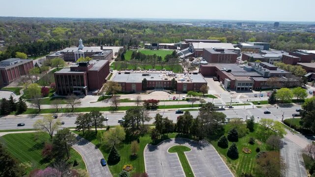 Aerial view of buildings and lush green trees along Dodge Street, creating a vibrant tapestry of textures and tones, Omaha, Nebraska, United States.