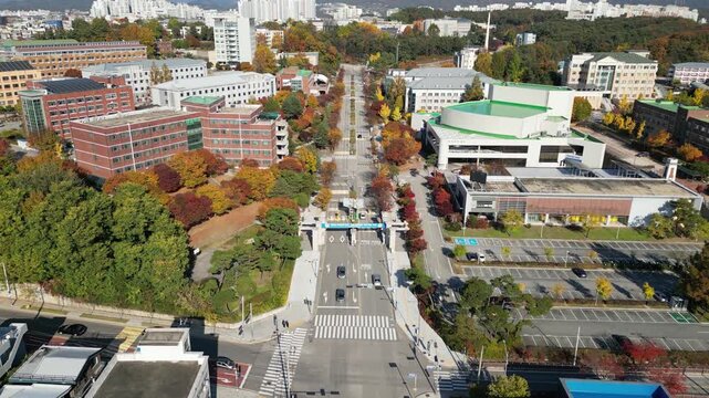 A comprehensive 4K aerial drone shot of Gangwon National University (KNU), a prominent national university located in Chuncheon, South Korea. The footage features a sweeping view of the grand main ent