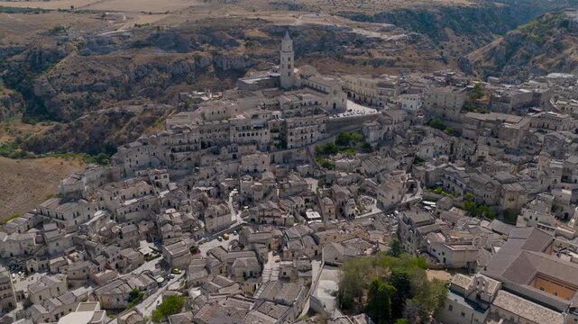 Aerial view of the ancient Sassi district in Matera, showcasing the stacked stone buildings and winding pathways, Matera, Basilicata, Italy.