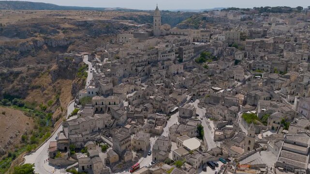 Aerial view of the ancient city of Matera, a mesmerizing tapestry of stone buildings blending into the rugged landscape, Matera, Basilicata, Italy.