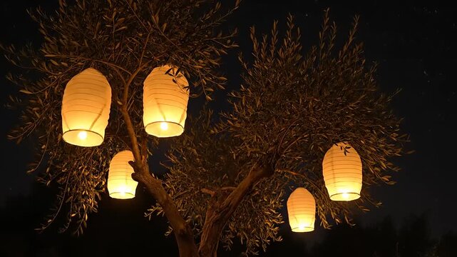 Glowing Lanterns Hanging from Tree Branches at Night.