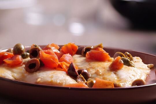  Piatto con filetti di orata,  olive, capperi e pomodorini