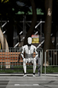 3D android sitting in city park during daylight hours