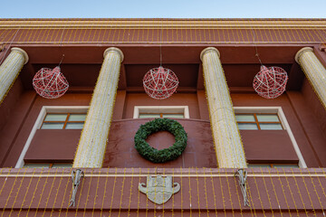Christmas wreath on city hall facade in Durr&euml;s.
Festive public decoration concept. Copy space.