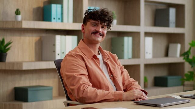 Caucasian business man complete work online smiling businessman close laptop smile looking at camera guy male entrepreneur finishing end job done working accomplishment success worker relax in office