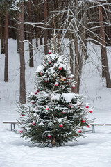 Christmas tree was decorated with Christmas tree decorations in a snowy forest