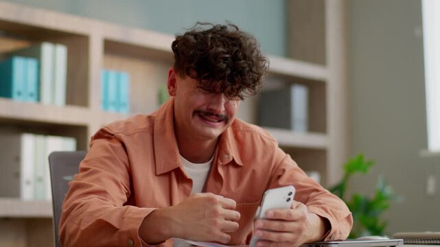 Disappointed Caucasian business man lost with mobile phone smartphone failure feeling sad bad bet result fail businessman male guy lose with gadget error receive terrible notification email in office