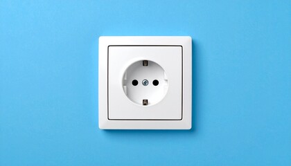 White electrical socket on blue wall background.