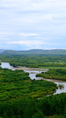 Obraz premium A sweeping panoramic view of Erguna Wetland in Hulunbuir, Inner Mongolia, showcasing vast rivers, forests, marshes, and seasonal color.