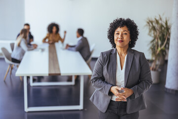 Confident Business Leader In Modern Office Surroundings Leading A Meeting With Colleagues